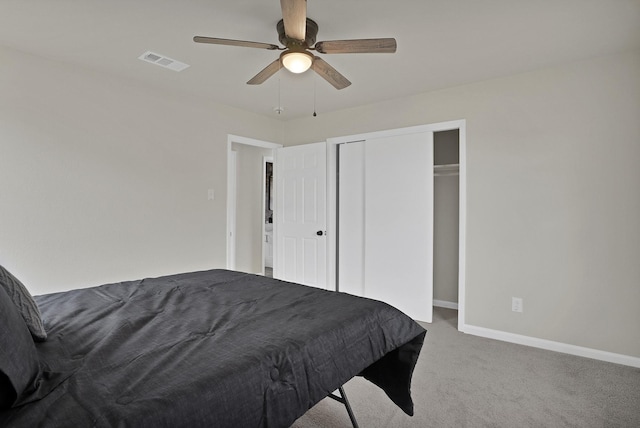 bedroom with a closet, visible vents, carpet flooring, ceiling fan, and baseboards