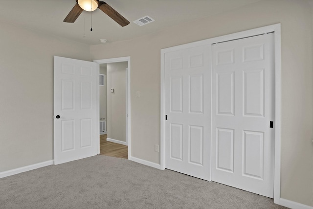 unfurnished bedroom with ceiling fan, carpet floors, visible vents, baseboards, and a closet