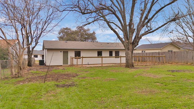 back of house featuring a fenced backyard, a lawn, and cooling unit