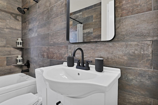 bathroom with vanity, shower / bath combo with shower curtain, toilet, and tile walls