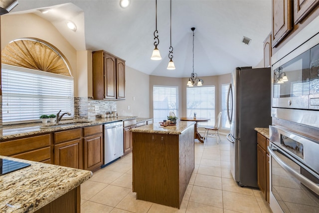 kitchen featuring a center island, light tile patterned floors, stainless steel appliances, tasteful backsplash, and visible vents