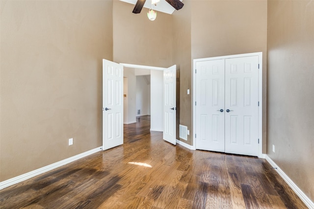 unfurnished bedroom featuring a closet, baseboards, and wood finished floors