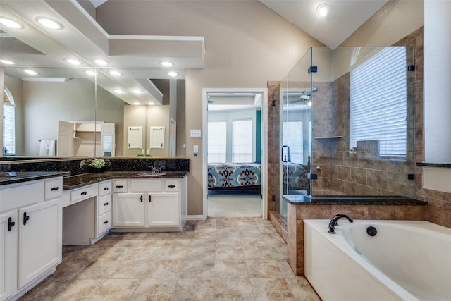 bathroom featuring a shower stall, vaulted ceiling, a bath, and vanity