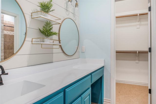 full bath featuring a walk in closet and vanity