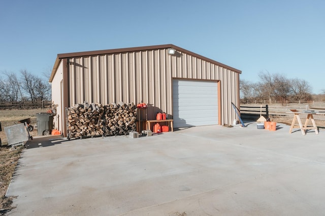 detached garage with concrete driveway