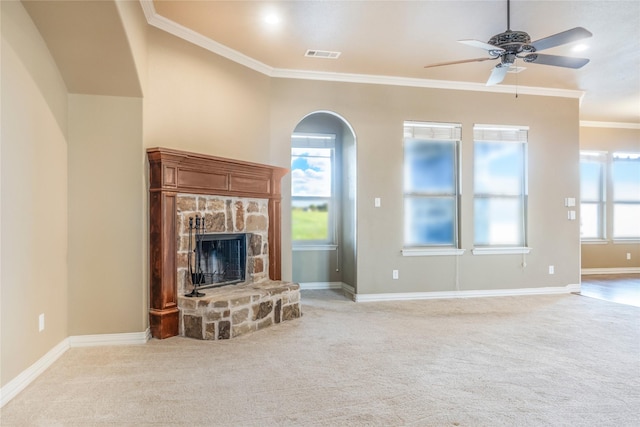 unfurnished living room with light colored carpet, visible vents, ornamental molding, and a stone fireplace