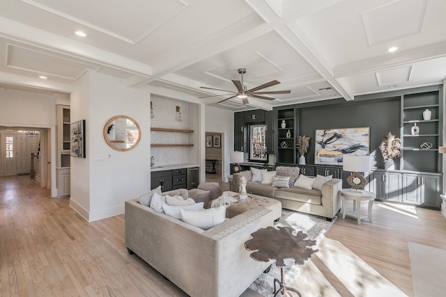 living area with light wood-style flooring, baseboards, coffered ceiling, and beamed ceiling