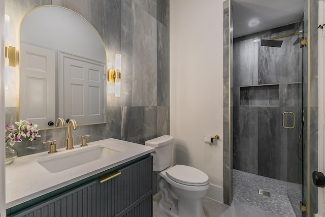 full bathroom featuring tile walls, tasteful backsplash, toilet, a stall shower, and vanity