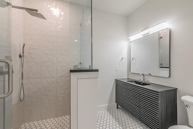 bathroom with toilet, a walk in shower, and vanity