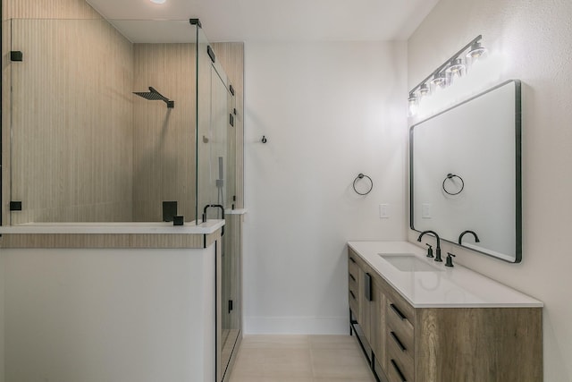 full bathroom with a stall shower, vanity, and baseboards