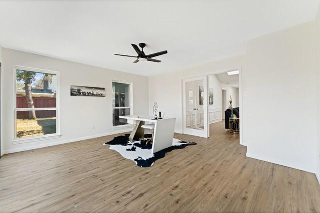 exercise room featuring ceiling fan, baseboards, and wood finished floors