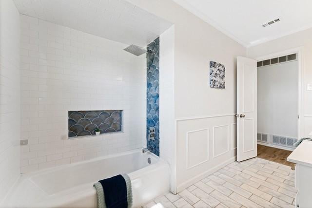 bathroom featuring shower / bath combination, wood finished floors, and visible vents