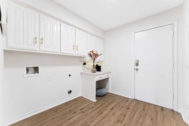 washroom featuring washer hookup, light wood-type flooring, cabinet space, and electric dryer hookup