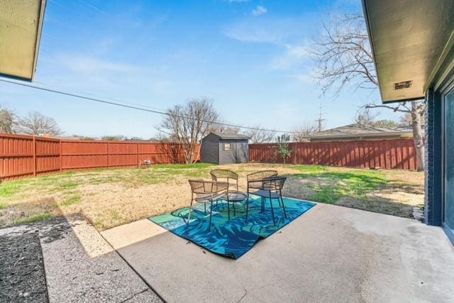 view of pool with an outbuilding, a yard, a storage unit, a patio area, and a fenced backyard