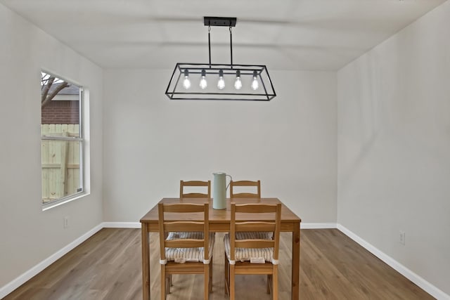 dining area with wood finished floors and baseboards