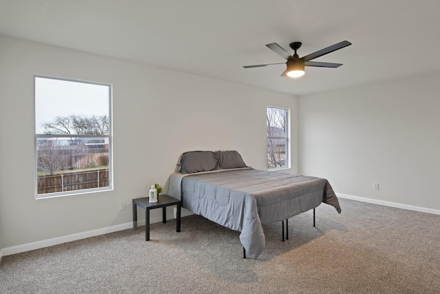 bedroom with carpet flooring, a ceiling fan, and baseboards