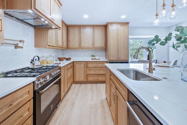 kitchen with tasteful backsplash, gas range, custom range hood, light brown cabinets, and a sink