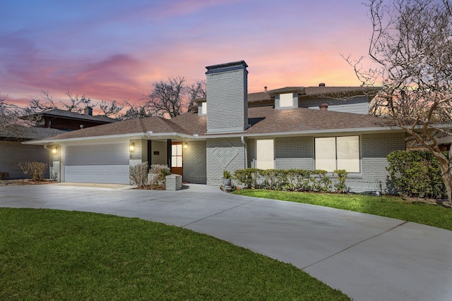 view of front of property with a garage, brick siding, a shingled roof, concrete driveway, and a front lawn