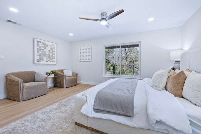 bedroom featuring ceiling fan, recessed lighting, wood finished floors, visible vents, and baseboards