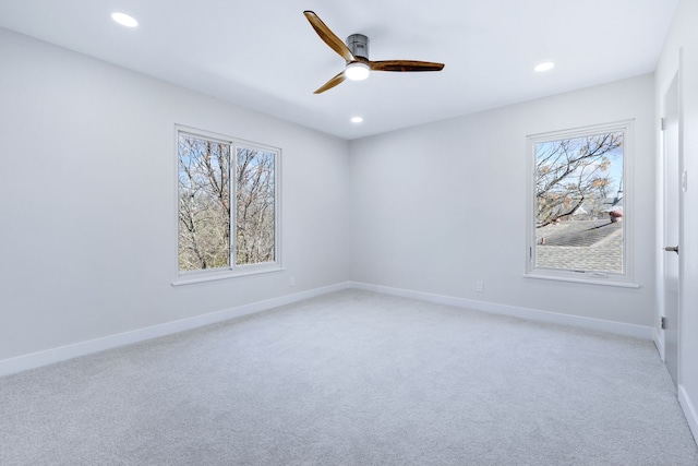 empty room featuring recessed lighting, plenty of natural light, and baseboards