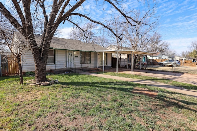 ranch-style house with concrete driveway, roof with shingles, covered porch, fence, and a front lawn