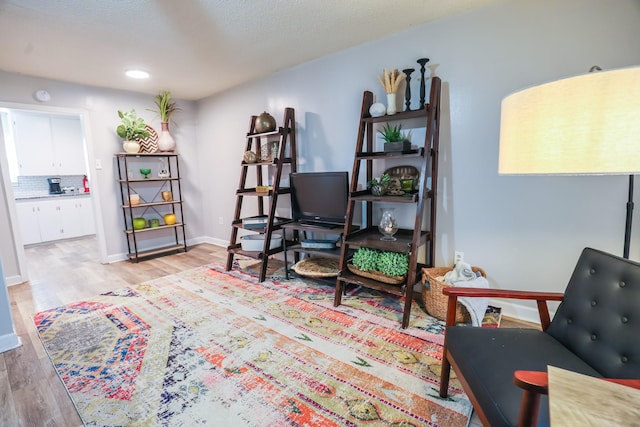 sitting room featuring light wood-style flooring and baseboards