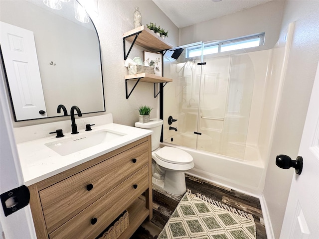 bathroom featuring toilet, combined bath / shower with glass door, a textured ceiling, vanity, and wood finished floors