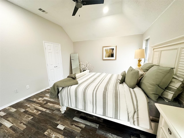 bedroom featuring dark wood finished floors, lofted ceiling, visible vents, a ceiling fan, and baseboards