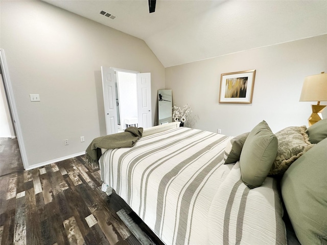 bedroom with baseboards, visible vents, a ceiling fan, lofted ceiling, and wood finished floors