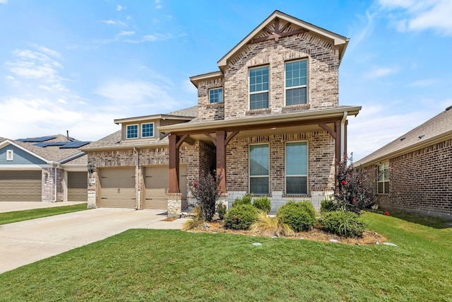 view of front facade with a front yard, concrete driveway, brick siding, and an attached garage