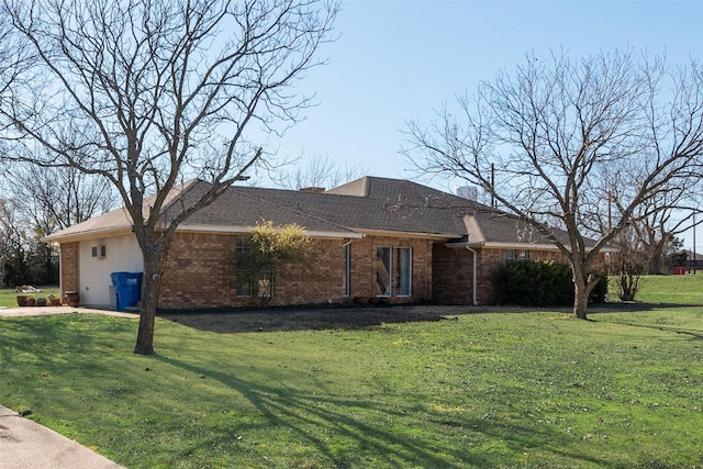 ranch-style home with brick siding, a chimney, and a front lawn