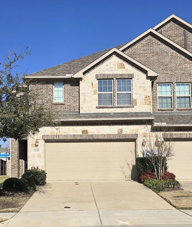 view of front of home featuring concrete driveway, stone siding, roof with shingles, an attached garage, and brick siding