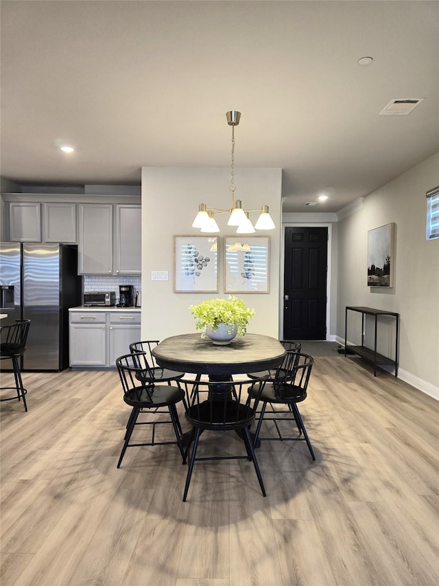 dining room featuring light wood-style flooring, recessed lighting, visible vents, and baseboards