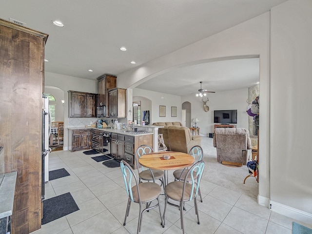 dining room with arched walkways, light tile patterned floors, a ceiling fan, and recessed lighting