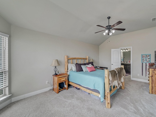 carpeted bedroom with visible vents, baseboards, connected bathroom, lofted ceiling, and ceiling fan