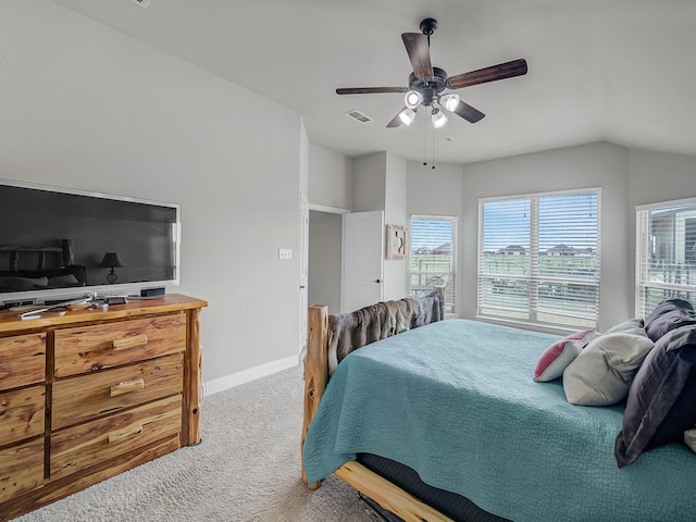 carpeted bedroom with vaulted ceiling, visible vents, ceiling fan, and baseboards