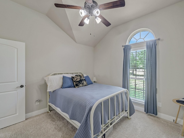 bedroom with a ceiling fan, baseboards, vaulted ceiling, and carpet flooring