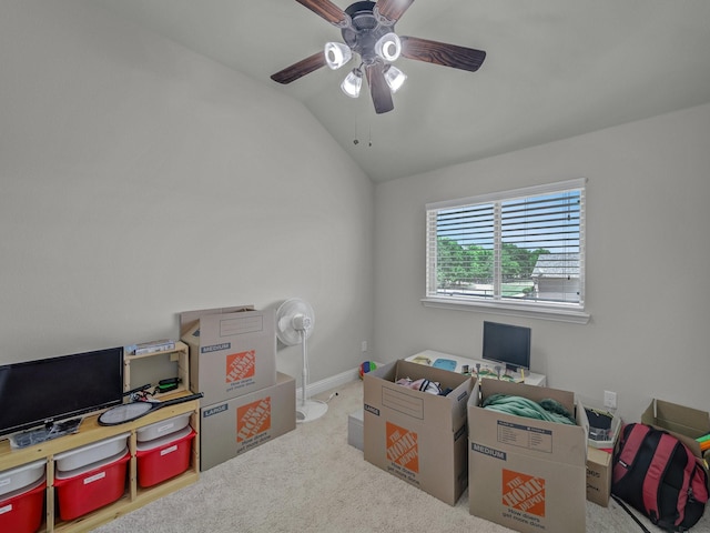 interior space featuring a ceiling fan, carpet, vaulted ceiling, and baseboards