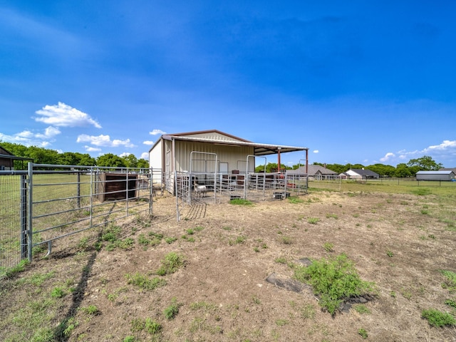 view of outdoor structure with a rural view, an exterior structure, and an outbuilding