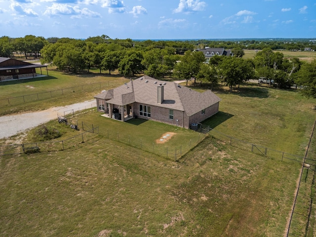 birds eye view of property with a rural view