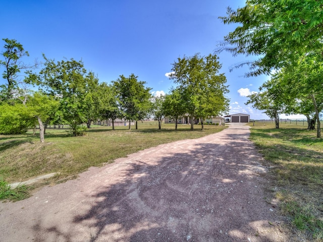 view of road with dirt driveway