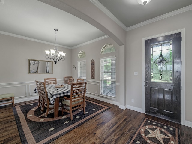 dining room featuring crown molding, arched walkways, dark wood finished floors, and a decorative wall