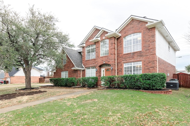 view of front of property featuring a front yard and brick siding