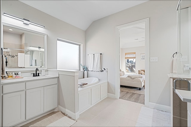 ensuite bathroom featuring a garden tub, ensuite bathroom, a tile shower, vanity, and tile patterned floors