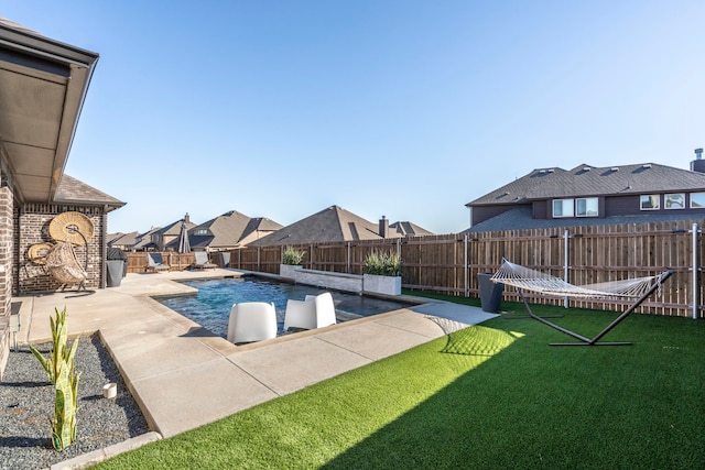 view of swimming pool with a patio, a lawn, a fenced backyard, and a fenced in pool