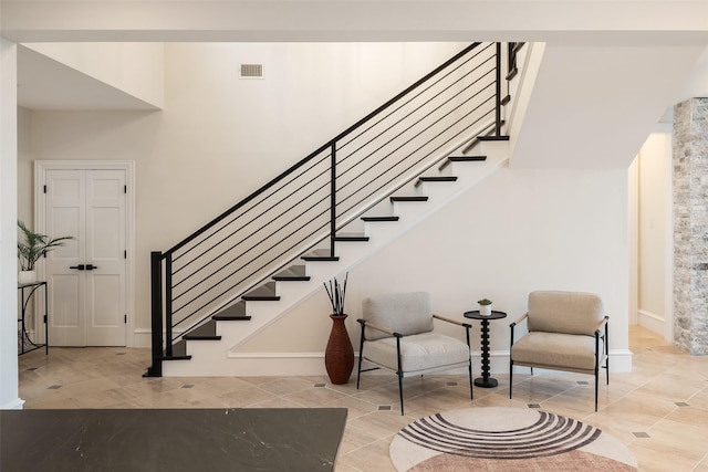 staircase featuring visible vents