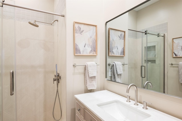 full bath with a shower stall and vanity