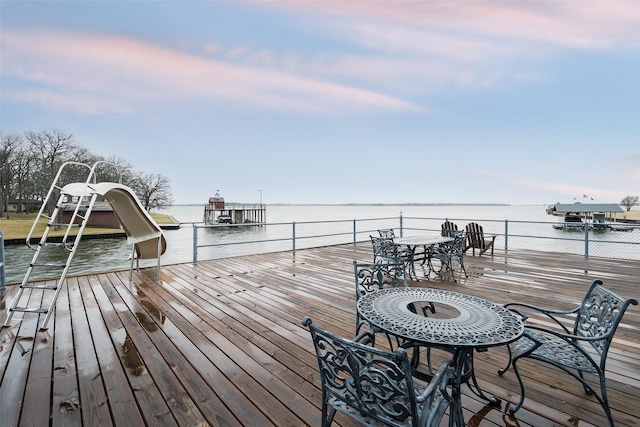 wooden terrace featuring a water view