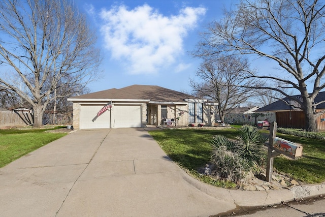 ranch-style home with a garage, driveway, and a front yard