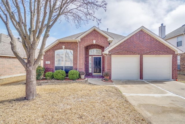 view of front of property with concrete driveway, brick siding, an attached garage, and a shingled roof